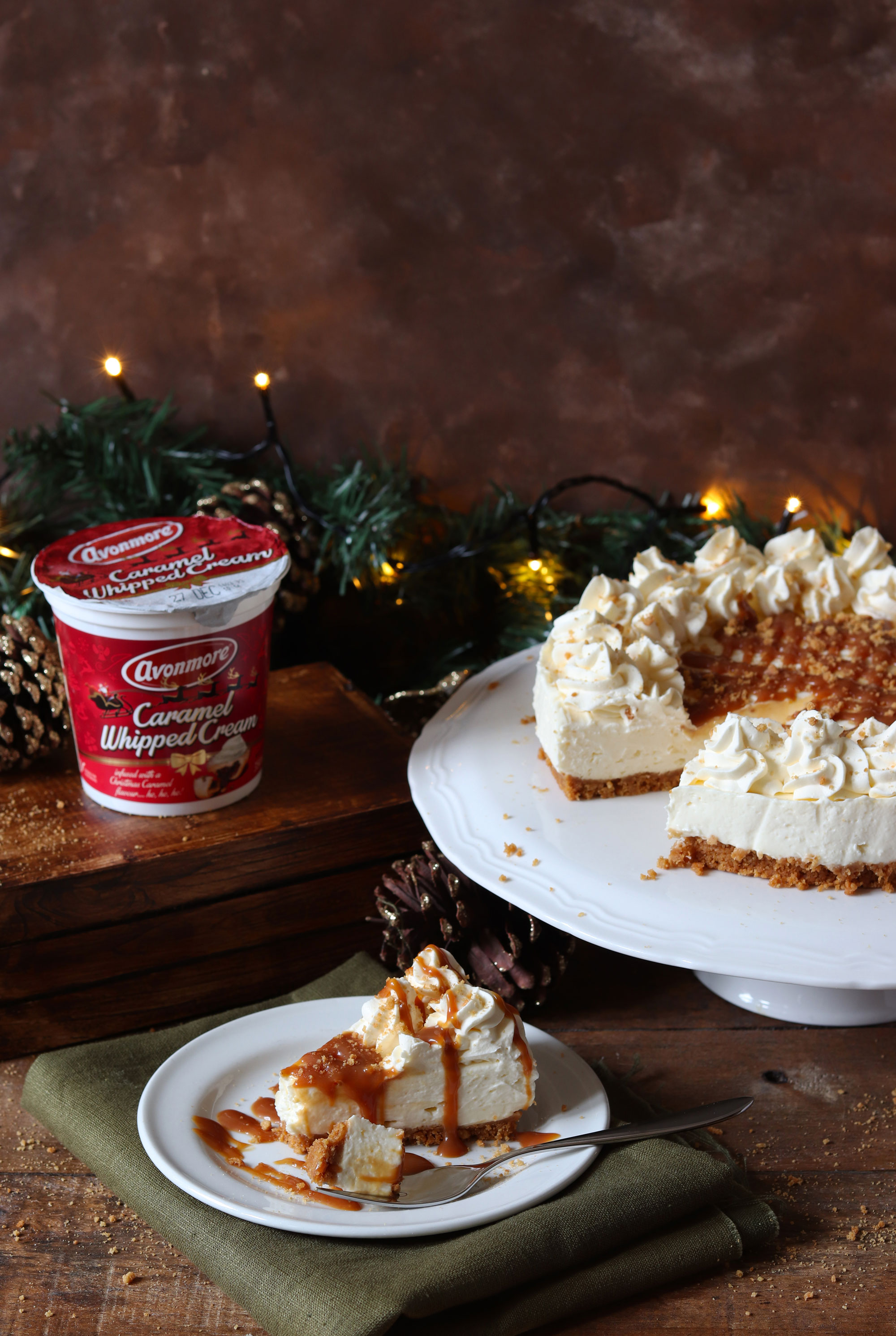 NO BAKE CARAMEL CHEESECAKE WITH A GINGER NUT CRUST AND AVONMORE CARAMEL WHIPPED CREAM FROSTING DRIZZLED WITH CARAMEL SAUCE