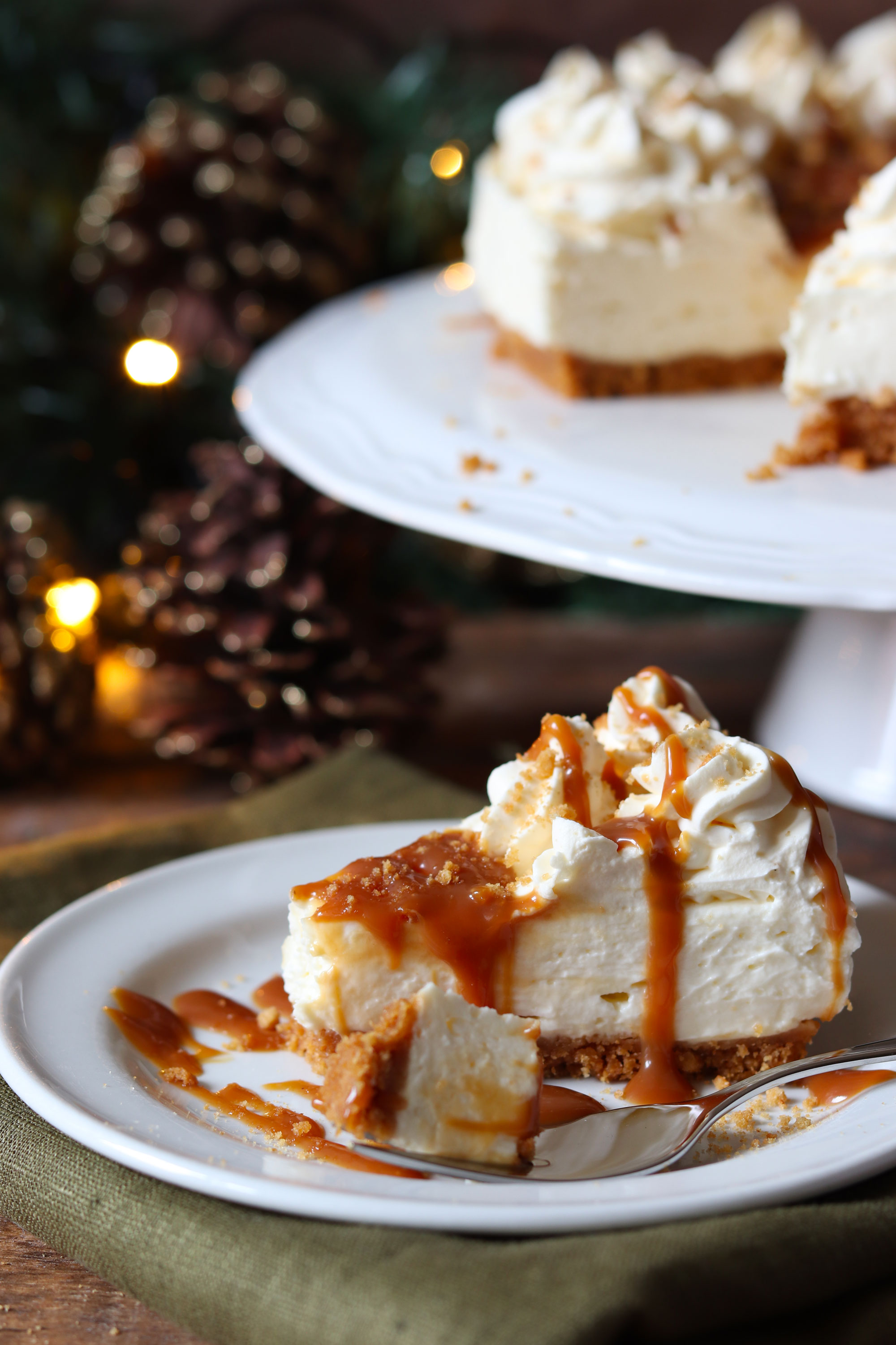 NO BAKE CARAMEL CHEESECAKE WITH A GINGER NUT CRUST AND AVONMORE CARAMEL WHIPPED CREAM FROSTING DRIZZLED WITH CARAMEL SAUCE