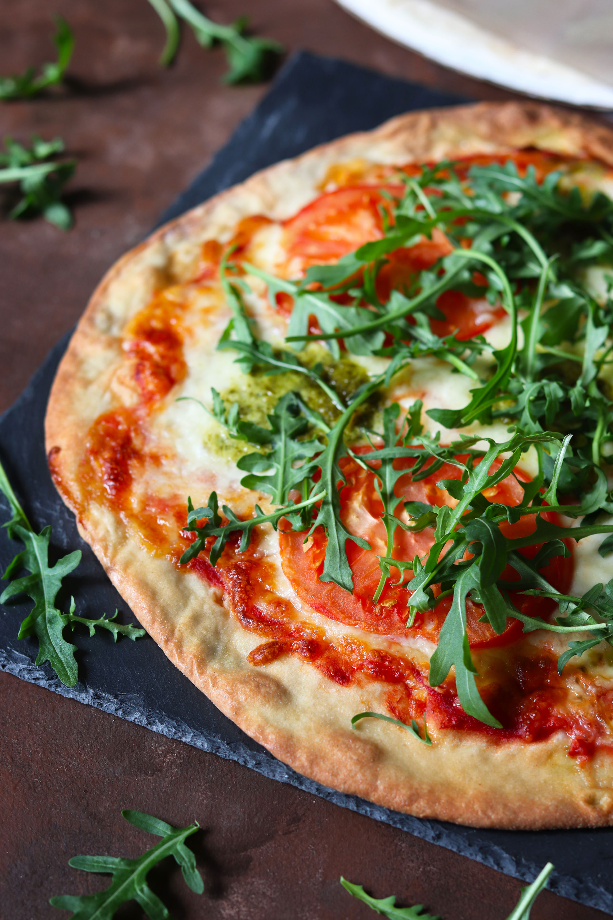 tomato mozzarella and basil pesto pizza