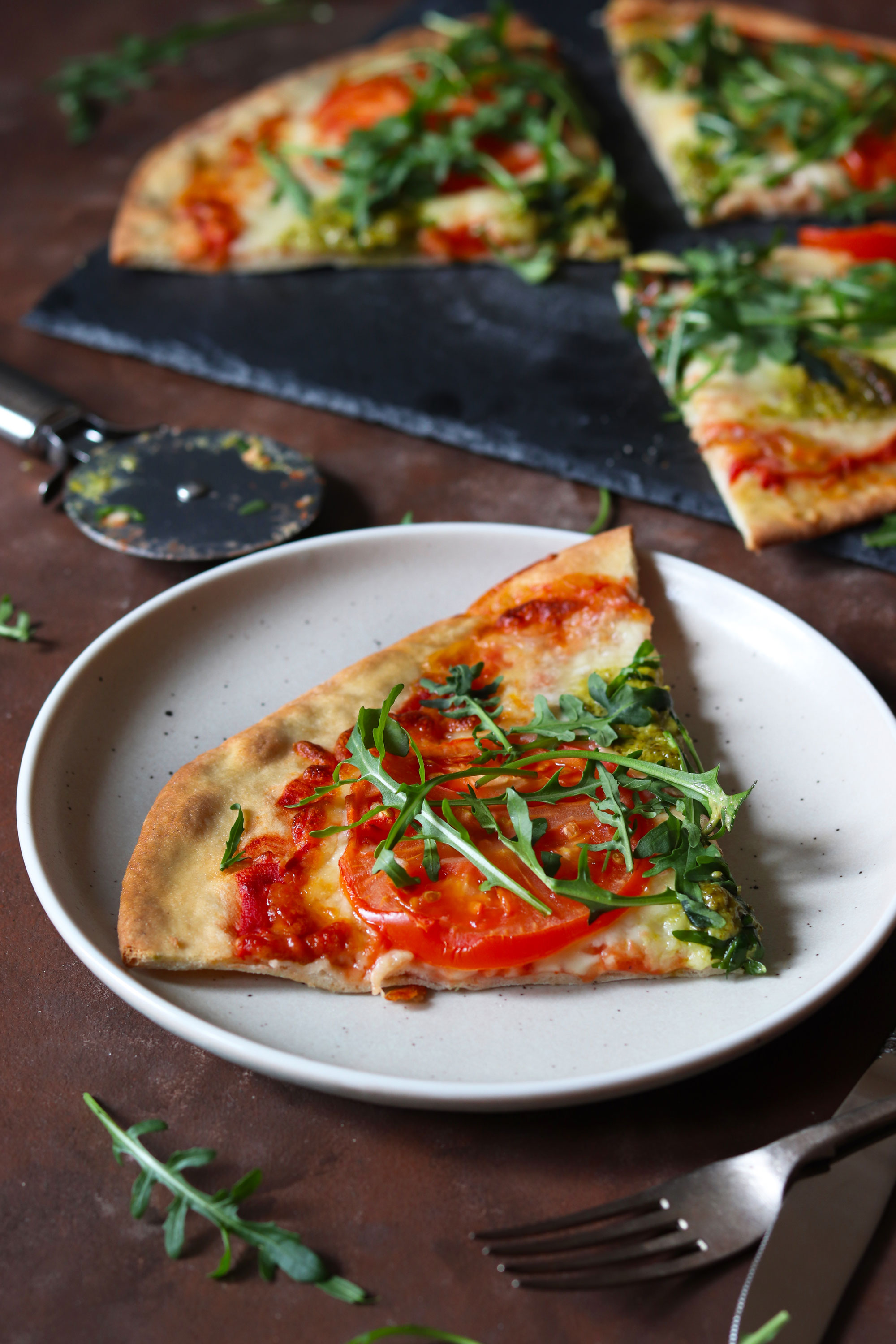 tomato mozzarella and basil pesto pizza